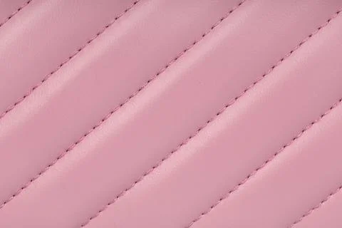 Close up of elegant pink quilted leather texture with diagonal stitched lines Stock Photos