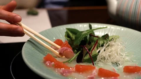 Close-up of elegant red snapper carpaccio with ruby grapefruit  at izakaya Stock Footage 335784316