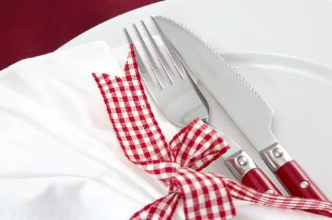 Close up of elegant red table setting - knife and fork for christmas Stock Photos