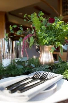 Close up of an elegant table setting, decorated with fresh flowers. Stock Photos