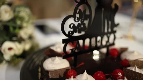 Close-Up of Elegant Wedding Cake with Chocolate, Cherries, Custom Topper Stock Footage 340550105