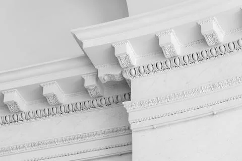 Close-up of an elegant white ceiling cornice corner showing ornate plaster .. Stock Photos