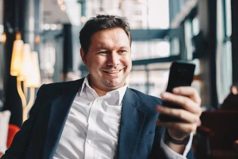 Close-up of elegant young man making a video call while sitting in a cafe bar Stock Photos