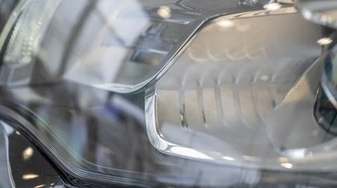 Close-up element of reflector of new car headlight headlight. Car background  Stock Photos
