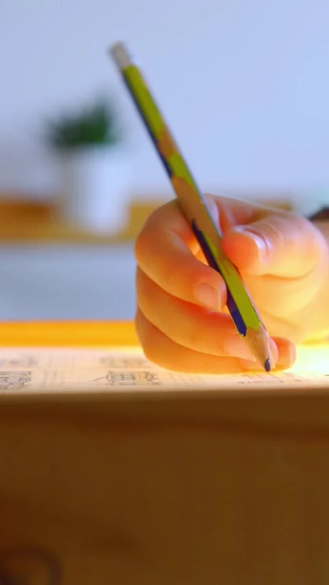 Close up of an elementary child drawing on a montessori light box vertical video Stock Footage 270796653