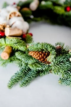 Close-up elements of Christmas wreath with red shiny beads with flowers of co Stock Photos