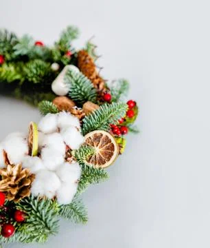 Close-up elements of Christmas wreath with red shiny beads with flowers of co Stock Photos