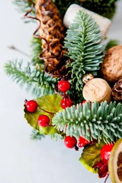 Close-up elements of Christmas wreath with red shiny beads with flowers of co Stock Photos