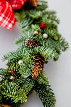 Close-up elements of Christmas wreath with red shiny beads with flowers of co Stock Photos