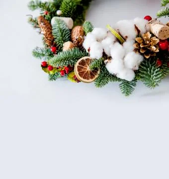 Close-up elements of Christmas wreath with red shiny beads with flowers of co Stock Photos