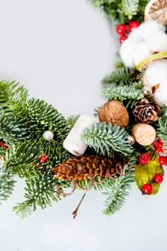 Close-up elements of Christmas wreath with red shiny beads with flowers of co Stock Photos