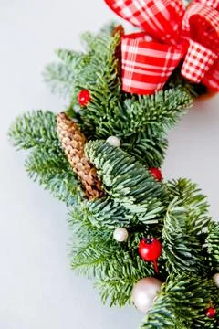 Close-up elements of Christmas wreath with red shiny beads with flowers of co Stock Photos