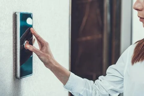 Close up of the elevator button and woman pressing it Stock Photos