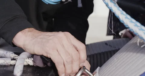 Close up of elite surfer David Langer attaching and fixing rope to rescue sled Stock Footage 163072220