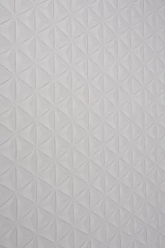 Close Up of Embossed Triangle Patterns on White Textured Surface Stock Photos