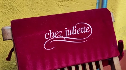 Close up of embroidered restaurant logo on red chair Video stock 336922629