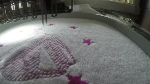 Close up of embroidery machine stitching a towel Stock Footage 54940929