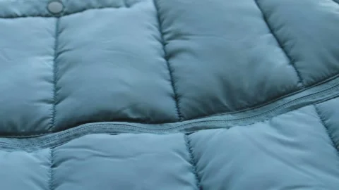 Close-up emerald green waterproof fabric texture of winter jacket, down jacket Stockbeeldmateriaal 224868152