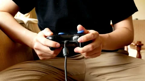 Close-up of emotional mixed race man playing video game pressing joystick button Stock-Footage 334653402