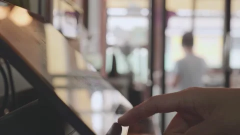 Close-up employee touches the screen of the automatic cash register and charges Stock Footage 148664426