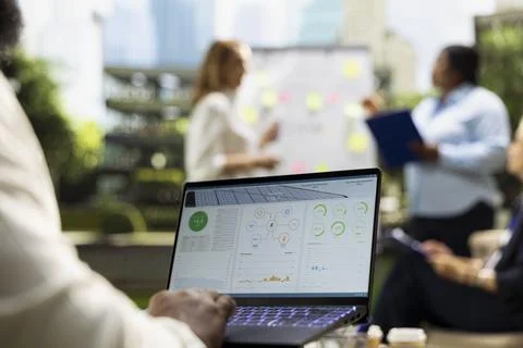 Close up of employee using solar panel energy software on laptop Stock Photos