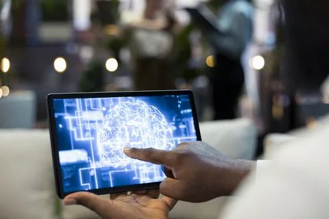 Close up of employee using tablet touchscreen to interact with AI assistant Stock Photos
