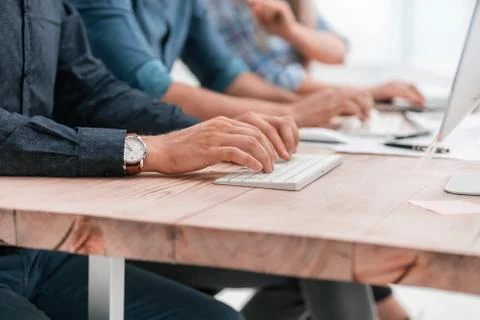 Close up. employees work with documents sitting at the table. Stock Photos