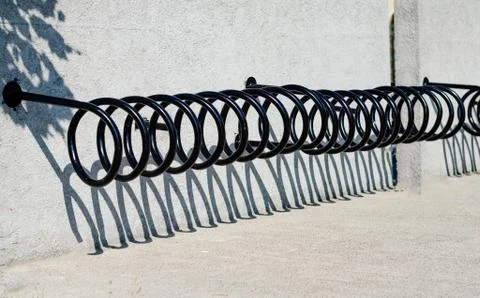 Close -up of empty bicycles  rake next to the wall . Public bicycle rental se Stock Photos