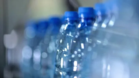 Close up of empty blue plastic bottles. Row of bottle in conveyer at water Video stock 334587793