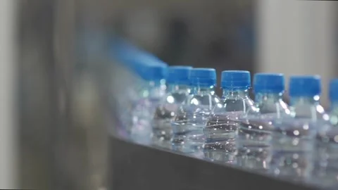 Close up of empty blue plastic bottles. Row of bottle in conveyer at water Video stock 334588267