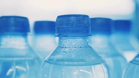 Close up of empty blue plastic bottles. Row of bottle in conveyer at water Video stock 334588366