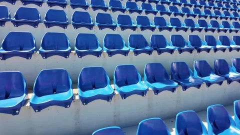 Close up of empty blue stadium seats forming a geometric pattern in bright .. Stock Footage 340516195