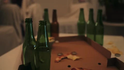 Close up of empty bottles, snack on table after party in living room. Video stock 264751880