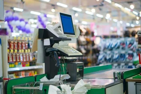 Close up of empty cash desk with computer terminal in supermarket Stock Photos