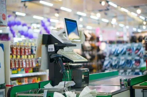 Close up of empty cash desk with computer terminal in supermarket Stock Photos
