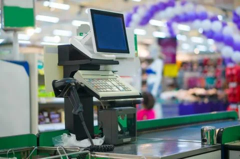 Close up of empty cash desk with computer terminal in supermarket Stock Photos
