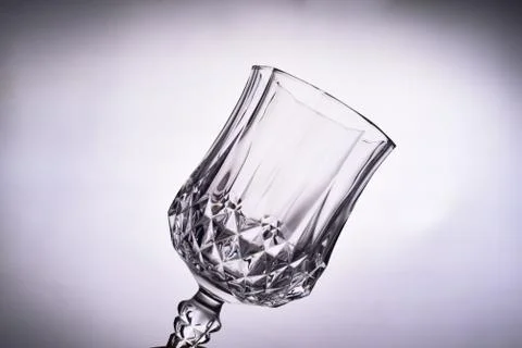 Close up of empty clean transparent Glass goblet against white background. Stock Photos