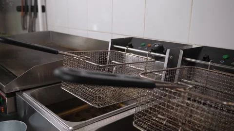 Close-up of empty deep-frying nets in the restaurants industrial kitchen. Stock Footage 345132456
