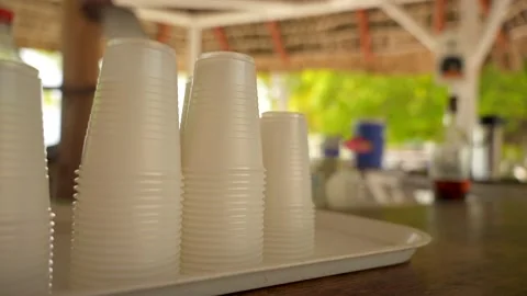 Close-up of an empty disposable plastic cups in stacks on a bar of a street cafe Stock Footage 218271165
