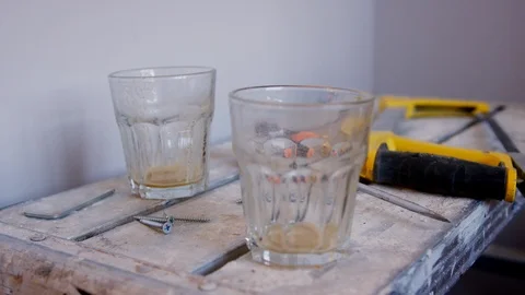 Close Up Of Empty Drinking Glasses On Workmans Trestle Table Stock Footage 90196556