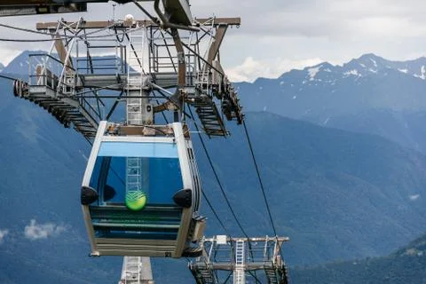 Close-up of an empty Elevator car that hangs in the air among the mountains. Stock Photos