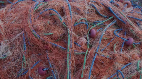 Close-up of empty fishing net in orange color. concept of fishing with net in Stock Footage 221278180