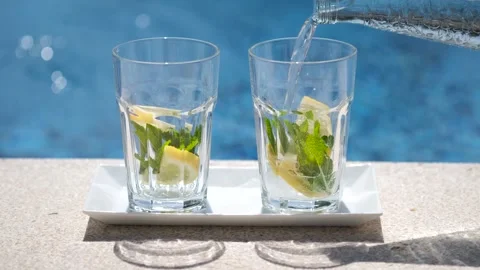 Close up of empty glasses on outdoor swimming pool or sea background. Stock-Footage 243996436
