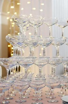 The close-up of empty glasses on the table is a pyramid. Beautiful ceremony.. Stock Photos