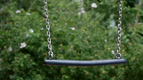 Close-up of An Empty Iron Swing With Trees In The Background, Selected Focus Stock Footage 132073384