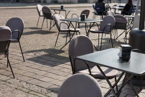 Close-up of empty iron table in outdoor restaurant or cafe. Lockdown times. Stock Photos