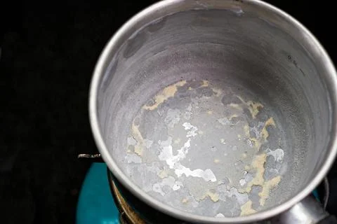 Close-up of an empty metal container with traces of scale. Stock Photos