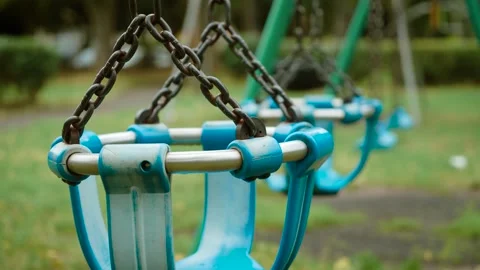 Close-up of empty playground basket swings with metal chains. Blue child swing Stock Footage 346037274