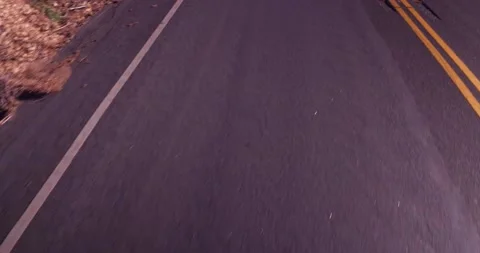 Close up of empty road from moving car Stock Footage 136341045