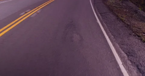 Close up of empty road from moving car Stock Footage 136341059